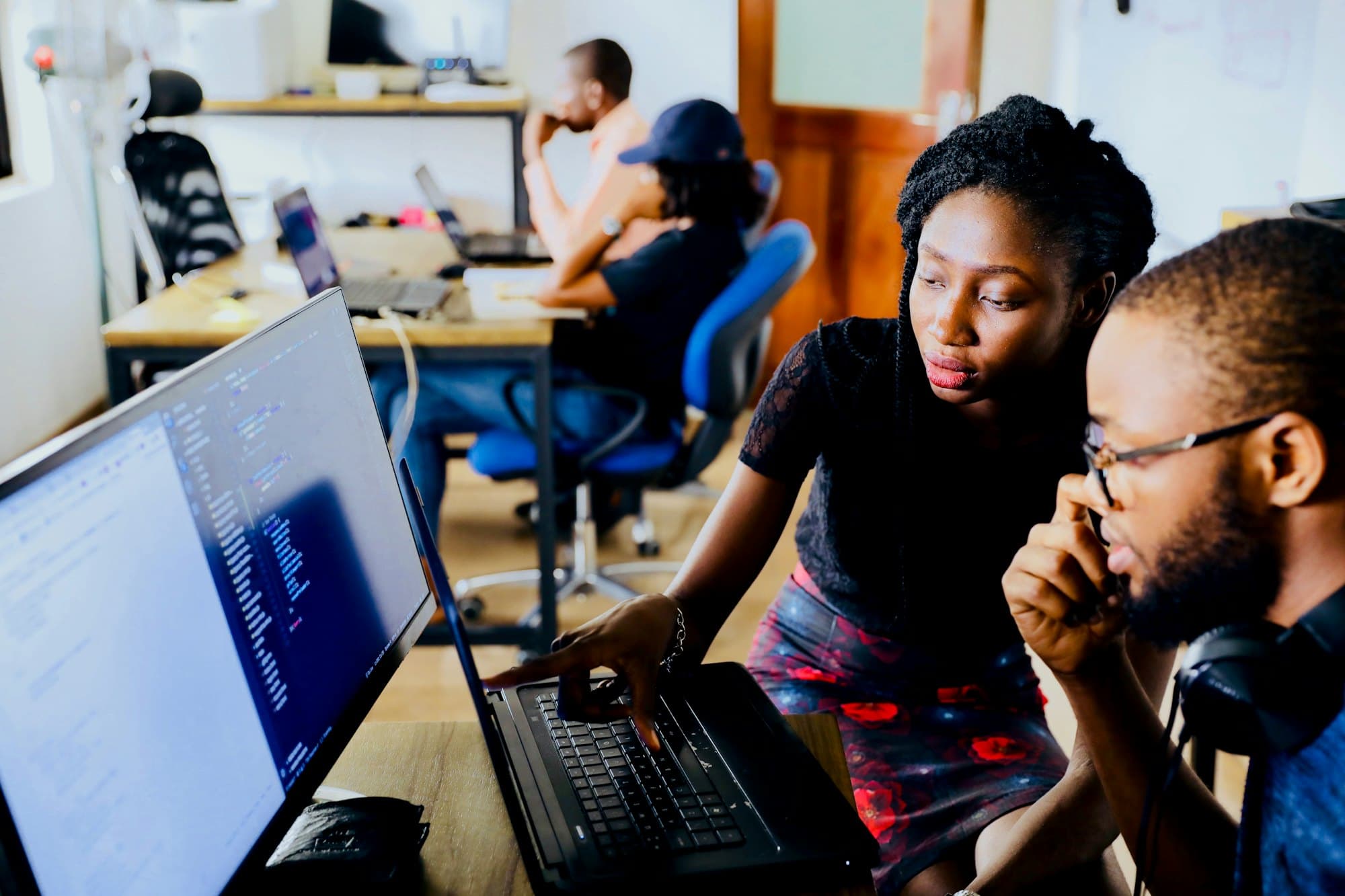 Software engineers working together at a laptop